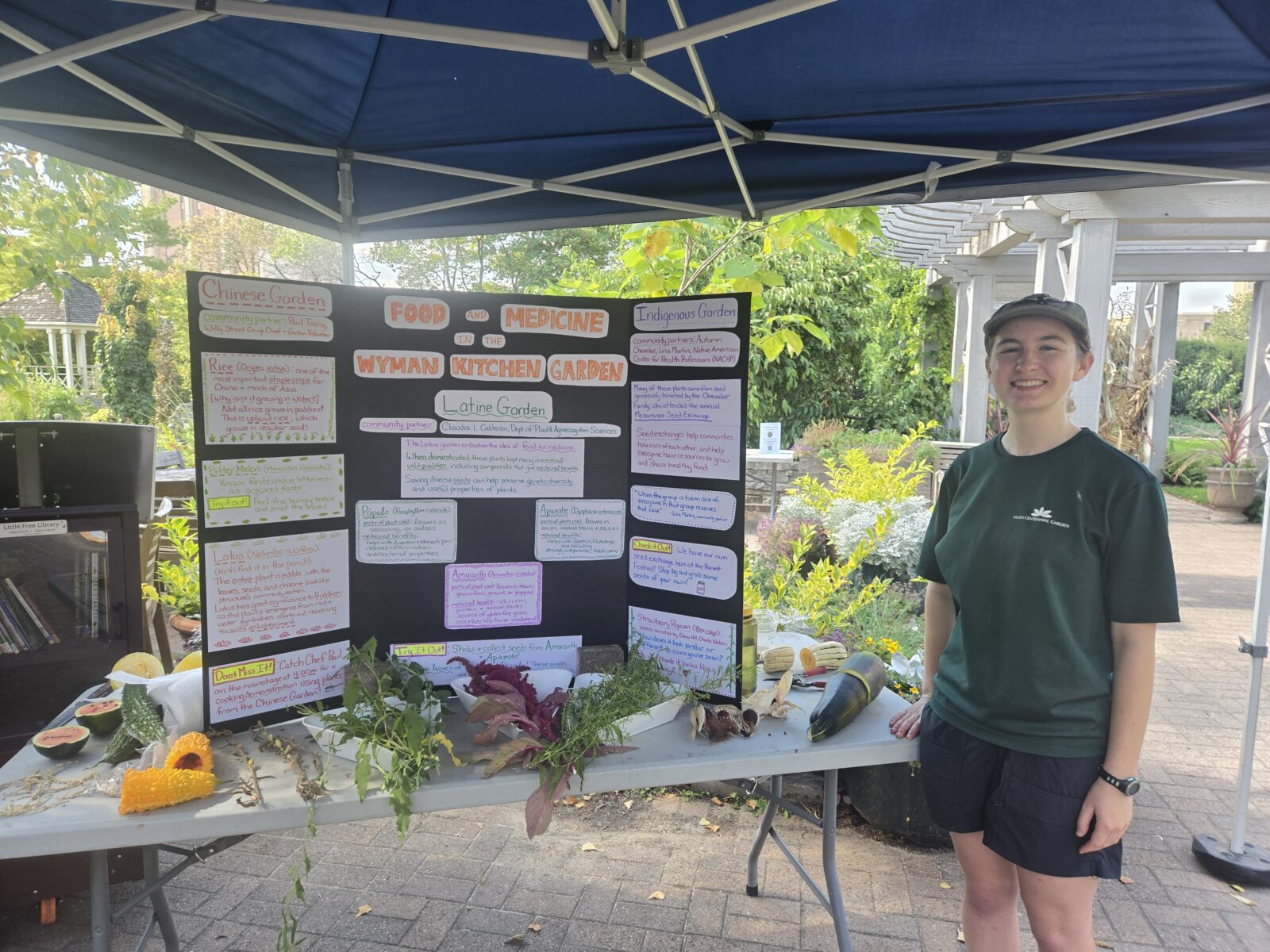 Smiling student next to project board