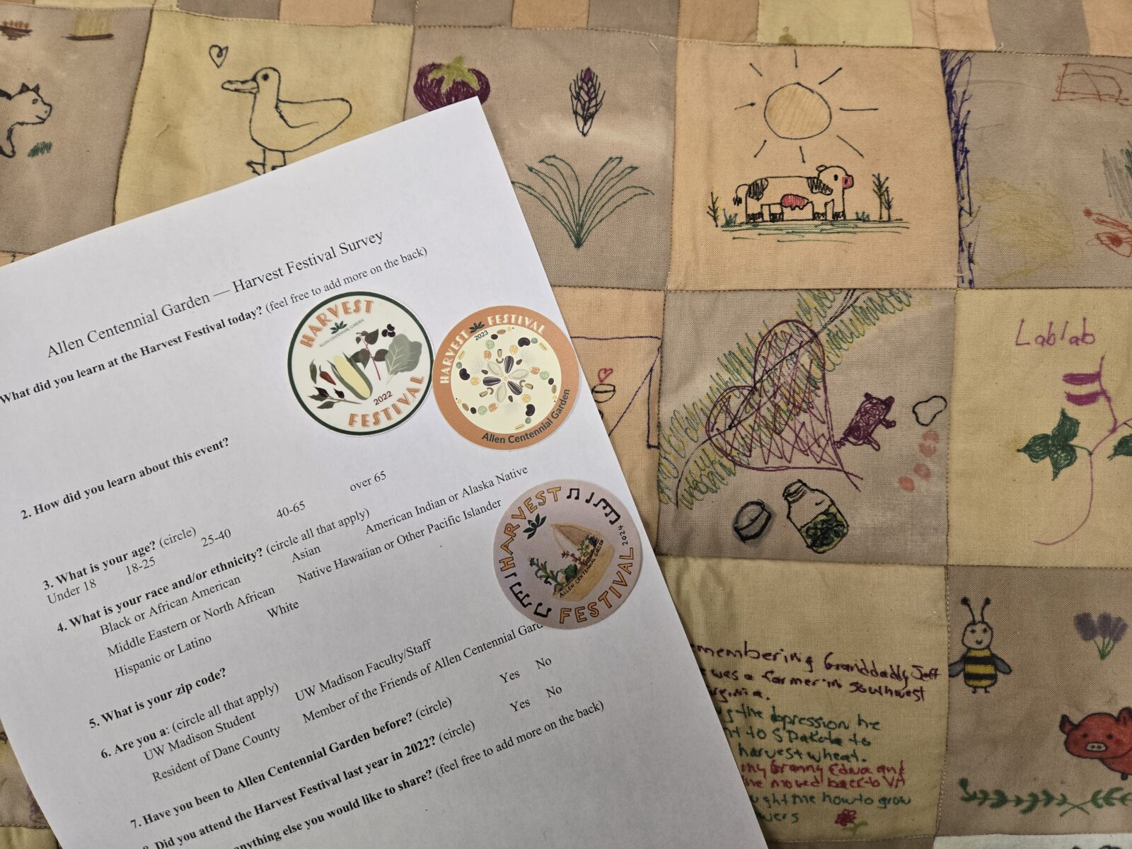 Stickers on top of a piece of paper and a quilt