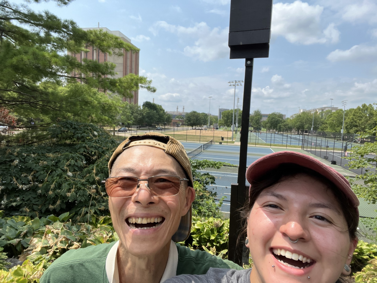 Eileen and Garden Volunteer Paul Tseng taking a selfie with the standing bat box on its post in the background