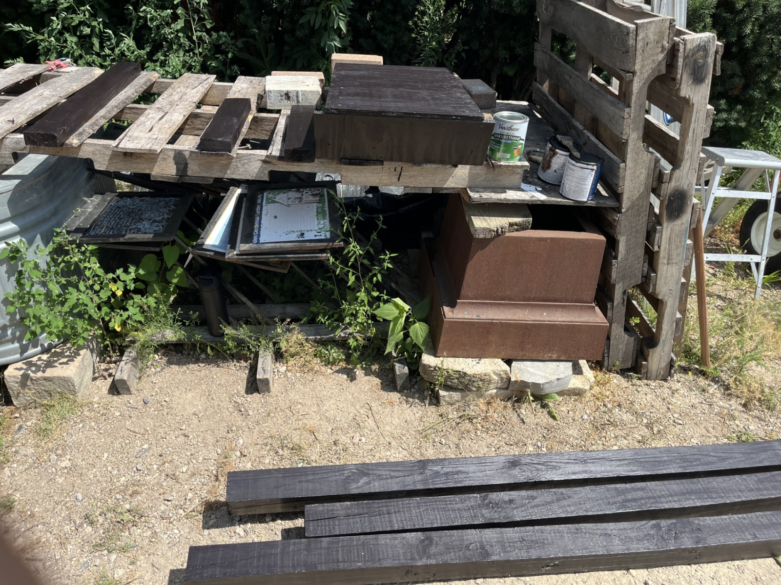 Image of all the parts (box and posts) laid outside after being stained a dark brown